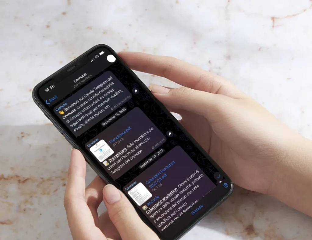 Telegram chat of a municipality open on smartphone with marble background for the service of the Digital Agency Jinni S.r.l.